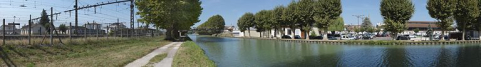 Panorama du canal traversant Migennes en direction de l'Yonne. A gauche, le site SNCF et la gare, à droite, la ville reconnaissable à ses halles. © Région Bourgogne-Franche-Comté, Inventaire du patrimoine
