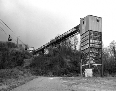L'entrée de la carrière. Au premier plan : silo à gypse, relié par convoyeur à l'atelier de concassage. © Région Bourgogne-Franche-Comté, Inventaire du patrimoine