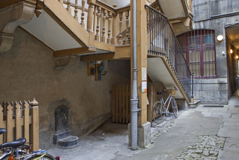 Escalier à cage ouverte de la première cour : détail du départ de l'escalier, de trois quarts gauche. © Région Bourgogne-Franche-Comté, Inventaire du Patrimoine