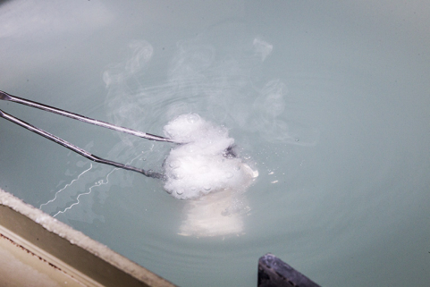 Fonte à la cire perdue : trempe du moule chaud dans l'eau. Le plâtre se désagrège. © Région Bourgogne-Franche-Comté, Inventaire du patrimoine