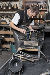 Moulage. Finition (percement d'orifices pour l'attache du battant). © Région Bourgogne-Franche-Comté, Inventaire du patrimoine