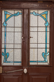 Porte de la cage d'escalier donnant sur le jardin, vitrail de style Art Nouveau. © Région Bourgogne-Franche-Comté, Inventaire du patrimoine