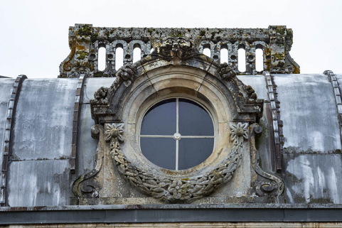 Lucarne percée d'un oculus et ornée de deux volutes, d'une guirlande et d'un félin. © Région Bourgogne-Franche-Comté, Inventaire du patrimoine Lucarne percée d'un oculus et ornée de deux volutes, d'une guirlande et d'un félin. © Région Bourgogne-Franche-Comté, Inventaire du patrimoine