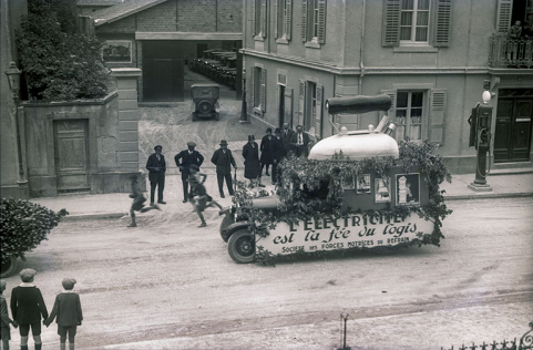 [Véhicule publicitaire de la Société des Forces motrices du Refrain, lors d'un corso fleuri à Montbéliard], [1ère moitié 20e siècle]. © Musées de Montbéliard