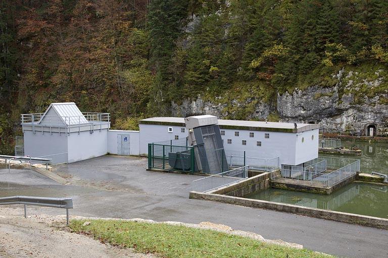 Barrage : prise d'eau et salle des machines (centrale du groupe de restitution) au premier plan, salle de commande des vannes toits à l'arrière-plan. © Région Bourgogne-Franche-Comté, Inventaire du patrimoine Barrage : prise d'eau et salle des machines (centrale du groupe de restitution) au premier plan, salle de commande des vannes toits à l'arrière-plan. © Région Bourgogne-Franche-Comté, Inventaire du patrimoine