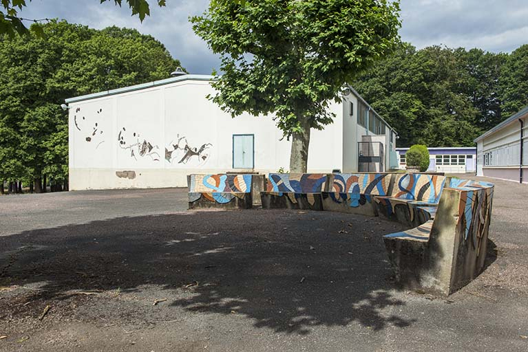 Espaces extérieurs : bancs  et pignon  du bâtiments avec fresques. © Région Bourgogne-Franche-Comté, Inventaire du patrimoine