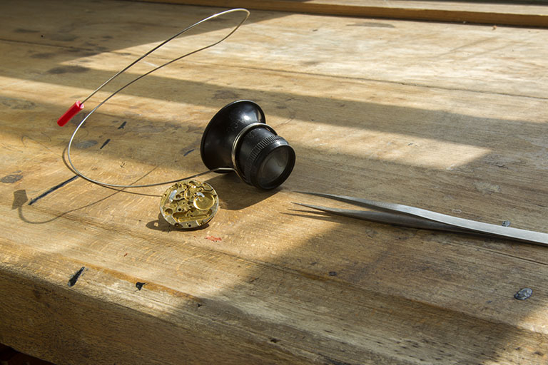 Atelier de fabrication : ébauche, brucelles et loupe d'horloger (dite "microscope" ou "micros"). © Région Bourgogne-Franche-Comté, Inventaire du patrimoine Atelier de fabrication : ébauche, brucelles et loupe d'horloger (dite "microscope" ou "micros"). © Région Bourgogne-Franche-Comté, Inventaire du patrimoine