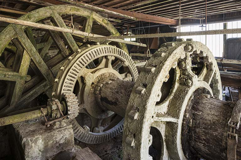 Arbre de couche couplé à la roue hydraulique. Au premier plan, couronne porte cames. © Région Bourgogne-Franche-Comté, Inventaire du patrimoine