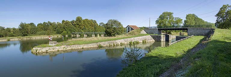 Vue sur la porte de garde et le barrage depuis l'amont au nord. © Région Bourgogne-Franche-Comté, Inventaire du patrimoine Vue sur la porte de garde et le barrage depuis l'amont au nord. © Région Bourgogne-Franche-Comté, Inventaire du patrimoine