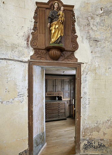 Depuis l'église, vue sur la sacristie. Vierge à l'enfant en couronnement de la porte. © Région Bourgogne-Franche-Comté, Inventaire du patrimoine Depuis l'église, vue sur la sacristie. Vierge à l'enfant en couronnement de la porte. © Région Bourgogne-Franche-Comté, Inventaire du patrimoine
