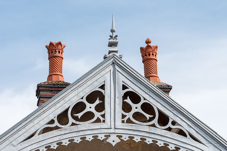 Lambrequin métallique découpé imitant un décor de menuiserie et cheminées ornées. © Pierre-Marie Barbe-Richaud / Région Bourgogne-Franche-Comté, Inventaire du patrimoine - 2019 Lambrequin métallique découpé imitant un décor de menuiserie et cheminées ornées. © Pierre-Marie Barbe-Richaud / Région Bourgogne-Franche-Comté, Inventaire du patrimoine - 2019