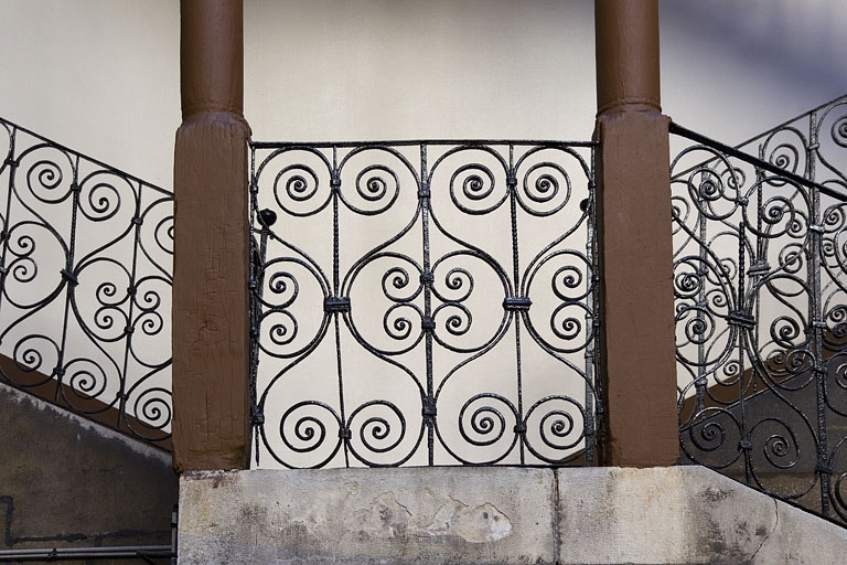 Escalier à cage ouverte à droite de la première cour : détail du décor de la rampe en ferronnerie. © Yves Sancey / Région Bourgogne-Franche-Comté, Inventaire du patrimoine - 2012