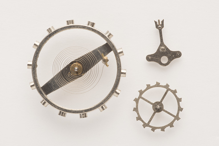 Vue d'ensemble de l'assortiment : balancier-spiral à gauche, ancre à chevilles en haut, roue d'ancre en bas. © Sonia Dourlot / Région Bourgogne-Franche-Comté, Inventaire du patrimoine - 2015