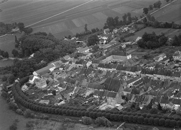 Vue aérienne d'une partie du village en 1956. Au centre, le couvent des carmes. © Région Bourgogne-Franche-Comté, Inventaire du patrimoine