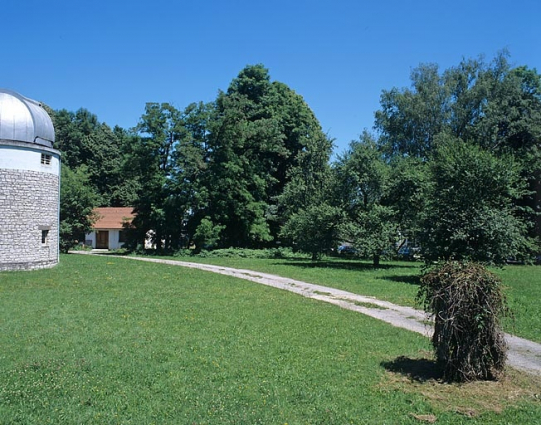 Partie nord : vue d'ensemble vers le bâtiment de l'astrographe, depuis l'entrée au sud. Groupe d'arbres associant châtaignier, frêne, épicéa, tilleul, érable, etc. © Région Bourgogne-Franche-Comté, Inventaire du patrimoine