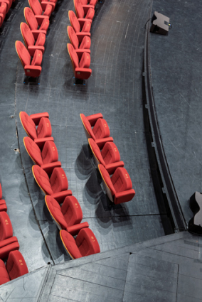 Maison de la culture, grande salle : vue plongeante sur la rangée de sièges au niveau de la fosse d'orchestre et du proscenium. © Région Bourgogne-Franche-Comté, Inventaire du patrimoine