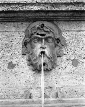 Détail : tête d'homme bouche ouverte sur le socle de l'obélisque, de face. © Région Bourgogne-Franche-Comté, Inventaire du patrimoine