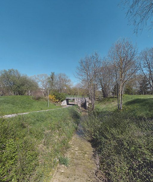 Déversoir du canal dans l'Ouche : rigole menant au pont de l'ancienne voie de chemin de fer Dijon-Epinac devenu piéton. L'ensemble fait aujourd'hui partie du parc entourant le lac Kir. © Thierry Kuntz / Région Bourgogne-Franche-Comté, Inventaire du patrimoine - 2011