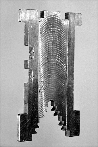 Matrice de caractères, de trois quarts. La matrice est duplexée : le côté droit est entaillé par les moules de deux caractères. © Jérôme Mongreville / Région Bourgogne-Franche-Comté, Inventaire du patrimoine - 2002